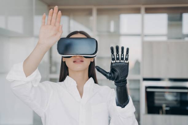 istock Female in virtual reality glasses training to use bionic prosthetic arm. Medical technologies 1438404313