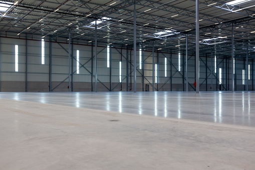 The inside of a big warehouse with windows