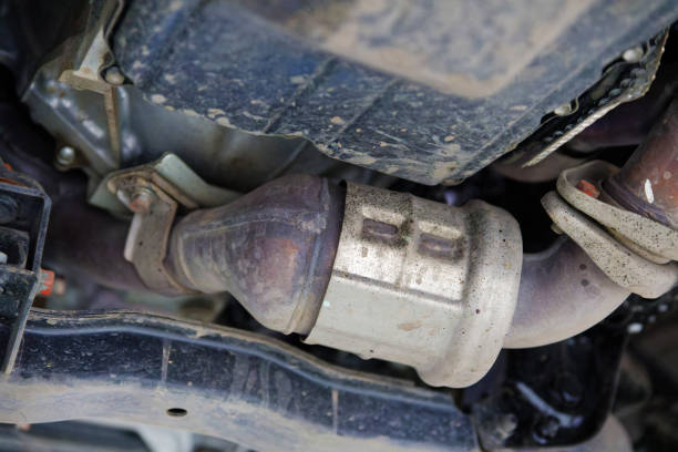 Closeup catalytic converter of a modern car bottom view. Shallow focus. Closeup catalytic converter of a modern car bottom view. Shallow focus. plug adapter stock pictures, royalty-free photos & images