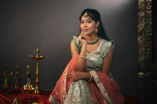 Young Indian woman getting ready to celebrate Diwali Festival