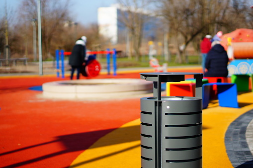 A closeup shot of a trash can in the children's playground