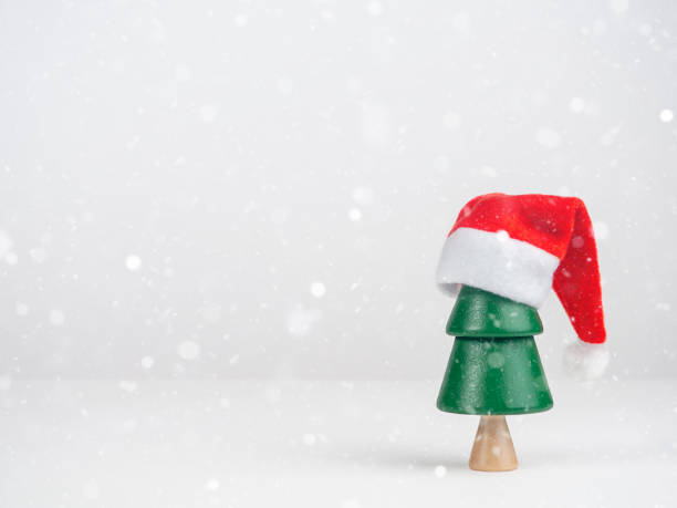 istock Christmas tree in a Santa hat on a light background. Christmas and New Year. 1438409340