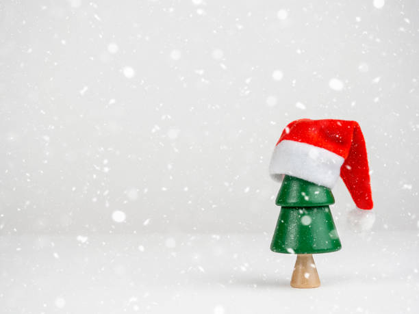 istock Christmas tree in a Santa hat on a light background. Christmas and New Year. 1438409341