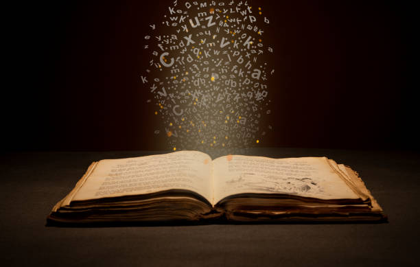 istock Vintage old book with English alphabets and magic light coming down 1438410479