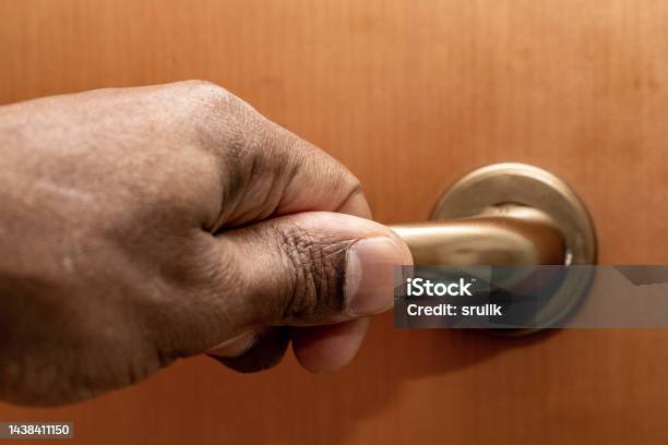 Male Hand On Doors Metal Handle Stock Photo - Download Image Now - Concepts, Door, Opening