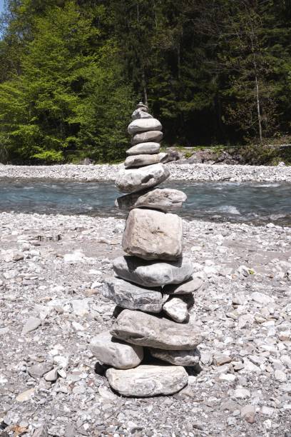 istock Vertical of a stack of stones captured by a river bank 1438412949