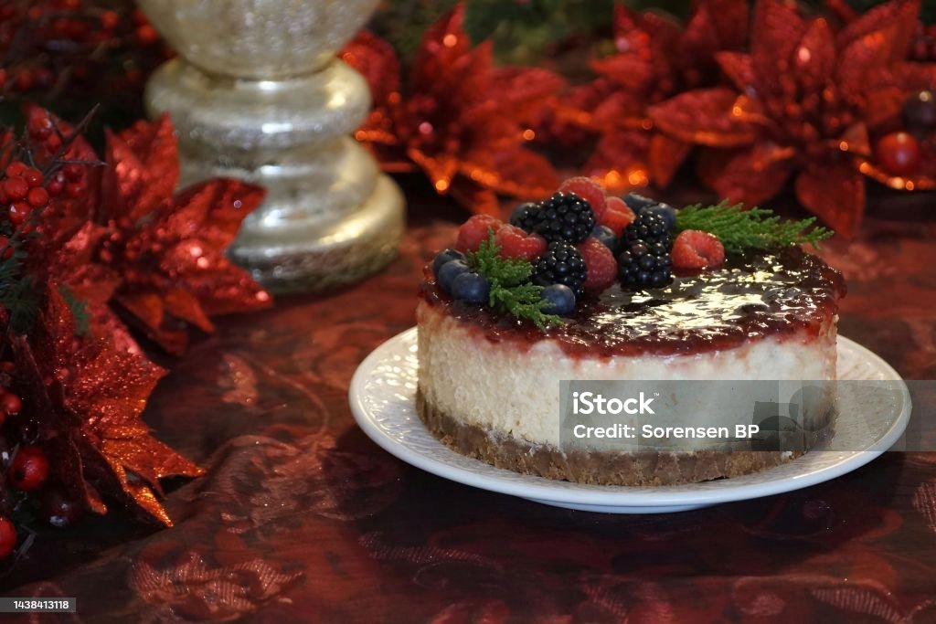 Christmas berry cheesecake Berry cheesecake surrounded by Christmas decorations Baked Stock Photo