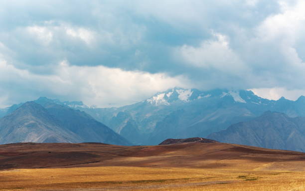istock Panoramic shot of a plain with mountains touching the sky in the background 1438413681