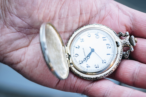 antique Swiss 14k gold pocket watch on wooden background