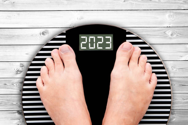 2023 feet on a weight scale, nutrition and diet new year card stock photo