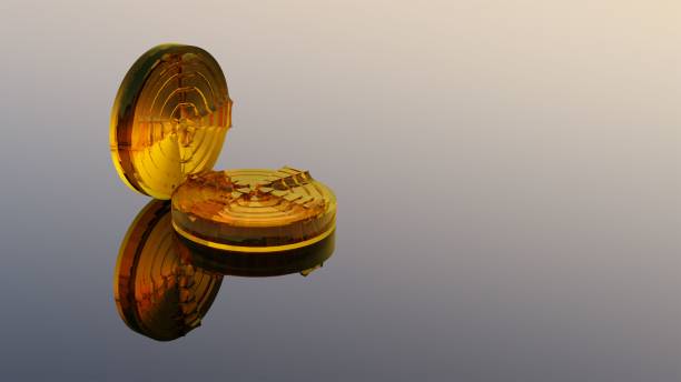 istock Shot of two gold coins reflected on a mirror background 1438417723