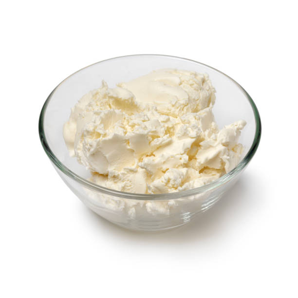 istock Glass bowl with clotted cream close up on white background 1438417866