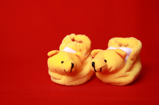 Baby shoes - Things with red background - Stock photo