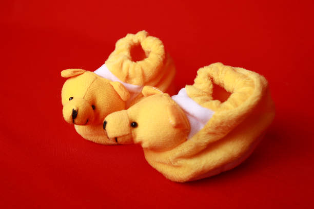 Baby shoes - Things with red background - Stock photo