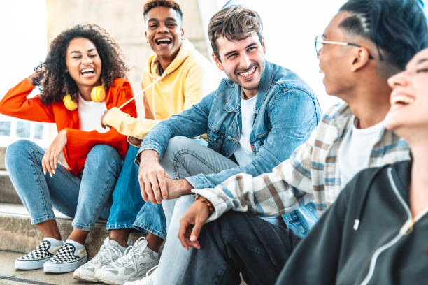 istock College students having sun sitting in university campus - Multiracial young people talking and laughing together hanging outside in the city - Friendship concept with guys and girls enjoying day out 1438420812