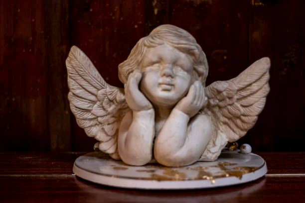white angel with gold on a wooden background