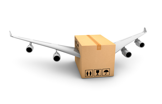 Cardboard with airplane wings on white background. Shipping concept.