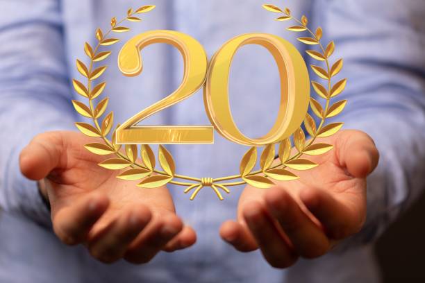 istock Number 20 next to a golden spike over someone's hand 1438432059