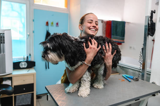 istock Young Female Caucasian Woman Smiling While Holding A Dog With Both Hands 1438433279