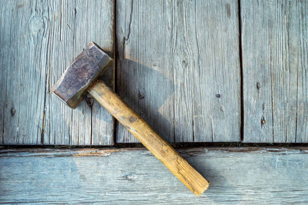 istock vintage hammer on weathered wooden boards background 1438434151