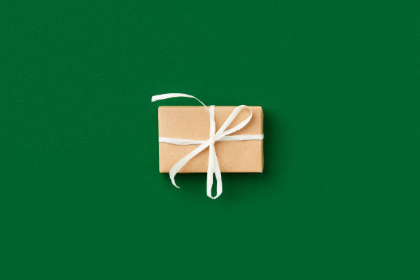 istock Christmas celebration concept. Gift on green background 1438435405