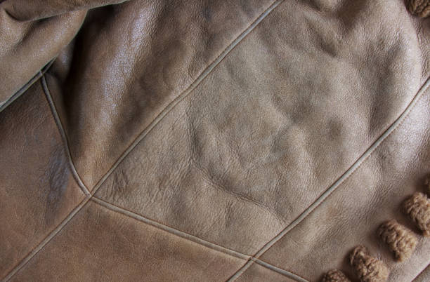 istock Background image of soft suede beige carpet. Dressing sheep wool closeup texture background. Top view. 1438436802