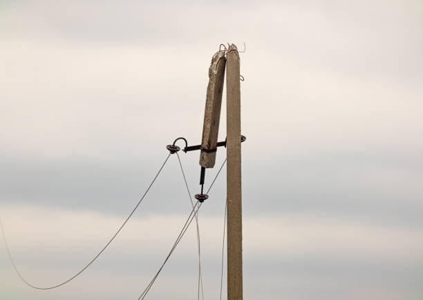 Broken electrical post in Kharkiv region, Ukraine. Electric wire of a broken high voltage pole is damaged