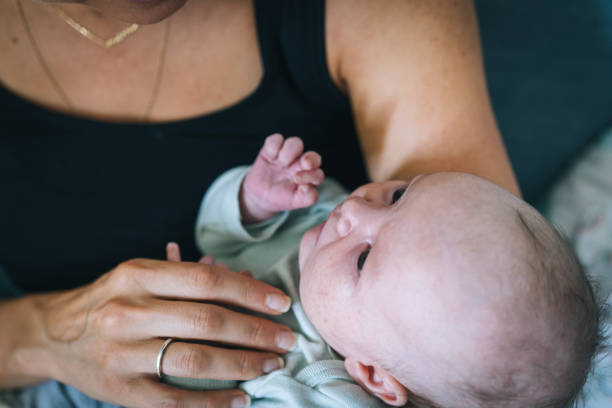 istock Mother cradles infant girl 1438440217