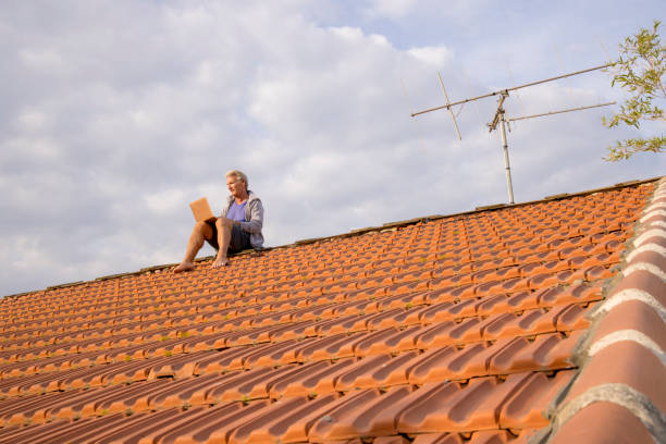 istock Senior man uses laptop on rooftop 1438440524