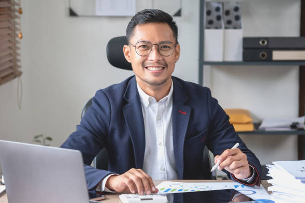 istock businessman use calculators and graph analysis computer laptop tablets to plan marketing strategies and make profitable investments for the company. 1438442289
