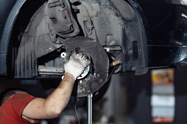 istock car wheel hub replacement in car service. 1438442691