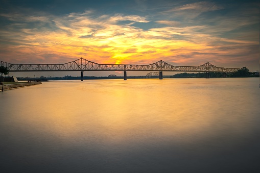 An aerial view of bridge over river during sunset