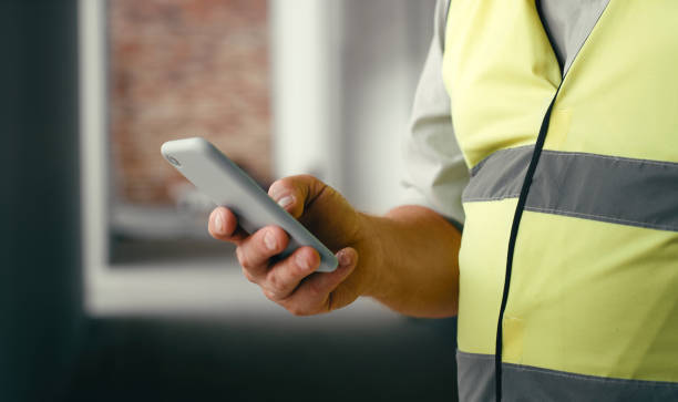 istock Engineer, phone and 5g network communication with contractor networking online for construction contact while working doing building maintenance. Hand of man using smartphone for project management 1438443069