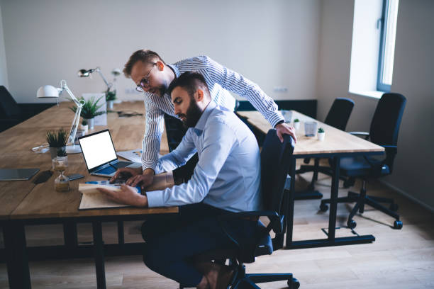 istock Caucasian office workers checking information from business literature searching solutions for doing financial accounting during work day in conference room, male colleagues brainstorming in workspace 1438443868