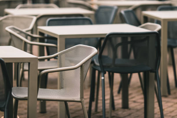 istock Tables and chairs in a room under the lights with a blurry background 1438447309