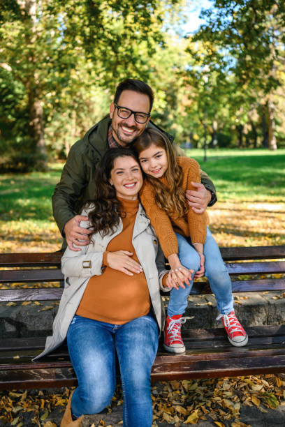 Happy family sitting in the park. stock photo