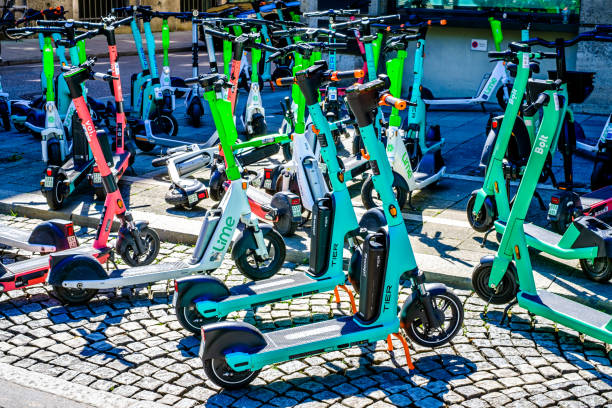 modern eScooter at a street Munich, Germany - August 23: typical modern eScooters at a street in the old town of Munich on August 23, 2022 lime scooter stock pictures, royalty-free photos & images