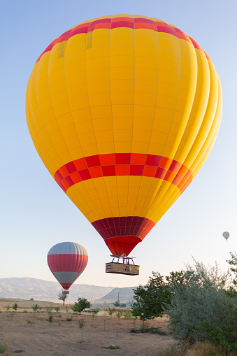 Colorful hot air balloon in flight over blue sky