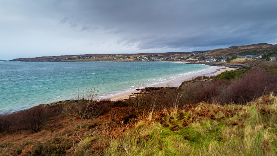 A high angle view of the town of Gairloch near the sea in Highlands, Scotland on a gloomy day