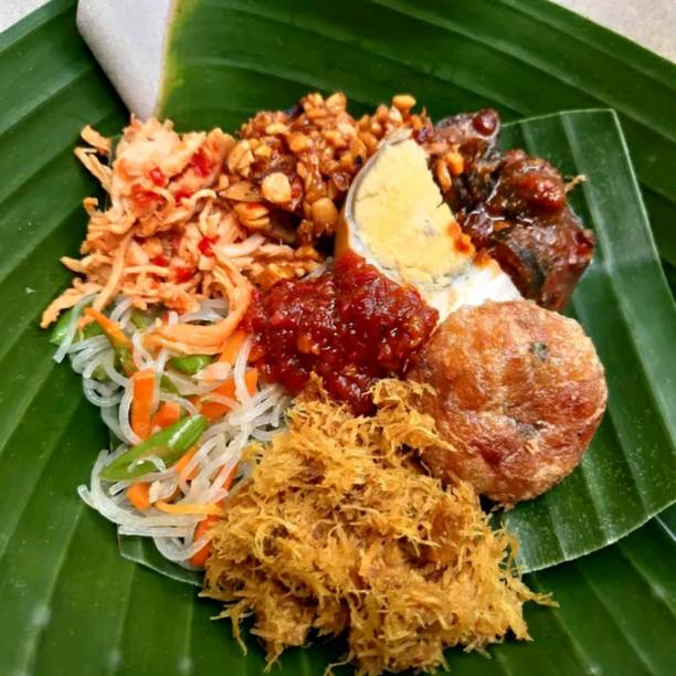 istock The banana leaf background has eggs, scrambled tempeh, vegetables, and a very delicious chili sauce 1438457772