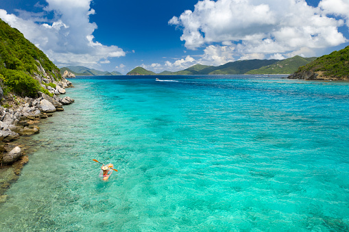 Woman kayaking on clear kayak in tropical water, Congo, Lovango, US virgin islands