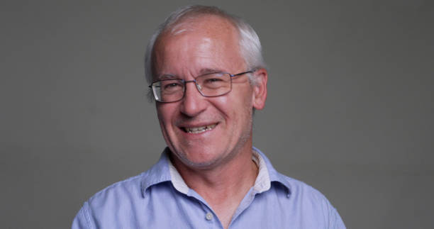 istock Smiling, laughing, happy man, looking at the camera on gray background 1438460387