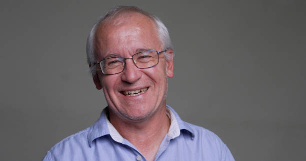 istock Smiling, laughing, happy man, looking at the camera on gray background 1438460420