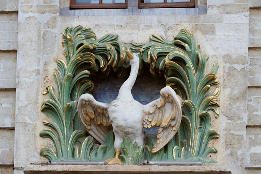 A close-up shot of a swan statue of the Swan House in Great Square in Brussels