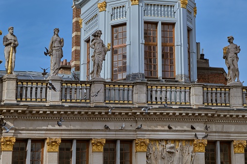 A close-up shot of the statues of Hercules, Ceres, Aeolus, and Mercury on the house of Boulangers in Brussels