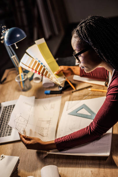 istock Architect deciding which color to go with for a project she is designing 1438467685