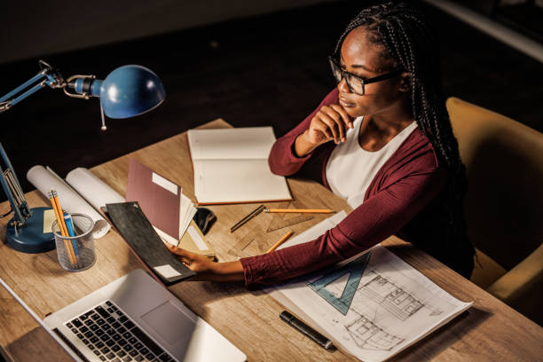 istock Architect reviewing color swatches for a project she is designing 1438468047