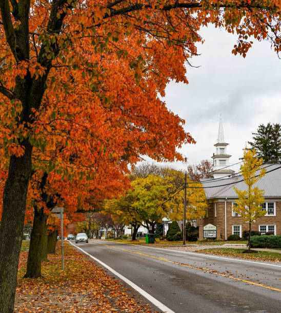 istock Church Framed by Orange Autumn Tree in Ohio Town 1438471653