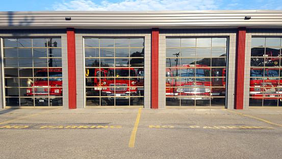 Armstrong, BC, Canada- September 29,2022: Four Fire trucks inside Fire hall garage  in small town Armstrong BC.  Just north of Vernon BC.