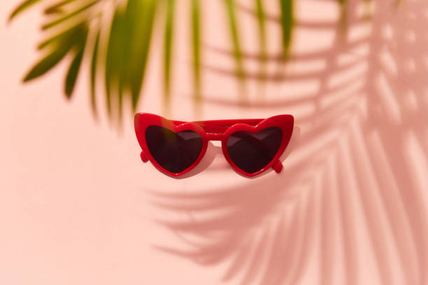 istock Red heart shaped sunglasses on pink background 1438475211